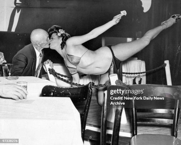 Willie Kelly watches Andrea Kinig of the Ha Ha Club do her striptease act.