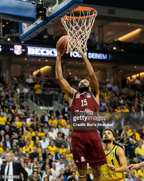 Reggie Redding of Bayern Muenchen competes with Joshiko Saibou of ALBA Berlin during the fourth play-off game of the German Basketball Bundesliga...