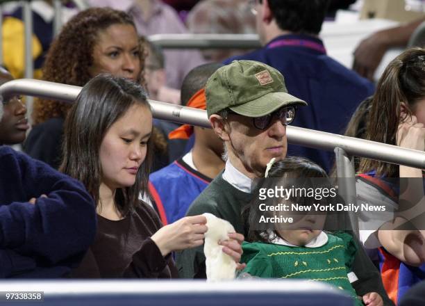 Woody Allen, wife Soon-Yi, and daughter Bechet Dumaine Allen are in attendance as the Knicks are defeated by the Philadelphia 76ers, 93-92, at...