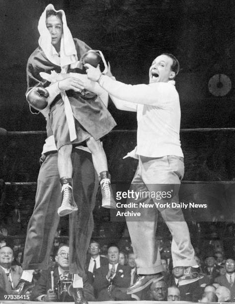 Willie Pep gets lifted by manager Lou Viscusi after regaining the featherweight championship in bout against Sandy Saddler at Madison Square Garden.