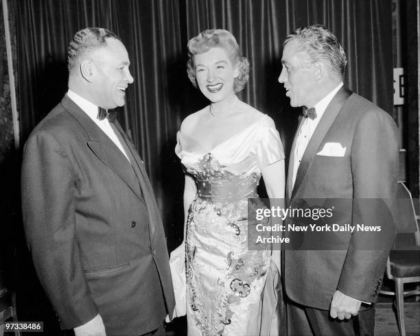 Dr. Ralph Bunche and Rise Stevens enjoy a laugh with Ed Sullivan, News columnist and TV star, at Friars Club testimonial dinner to Sullivan at...