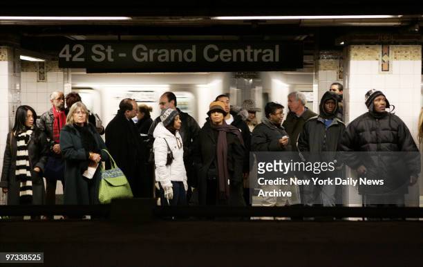 Passengers wait for a train at the 42nd St. - Grand Central subway station in Manhattan. New Yorkers are once again bracing for a possible transit...