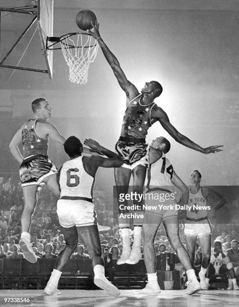 Wilt Chamberlain taps in a rebound for the All-Stars against the Knicks at Madison Square Garden. It was Chamberlain's last amateur appearance.
