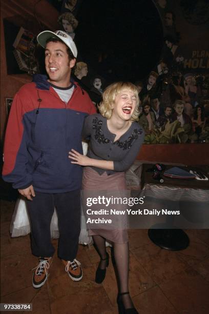 Drew Barrymore and Adam Sandler promoting their movie "The Wedding Singer" at Planet Hollywood.