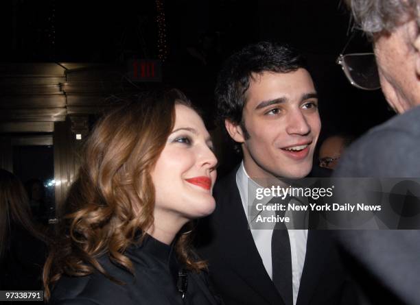 Drew Barrymore and boyfriend Fabrizio Moretti, a drummer with the band The Strokes, chat with author Kurt Vonnegut during a pre-Grammy party in the...