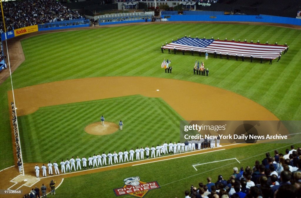With a large American flag adorning centerfield, the players