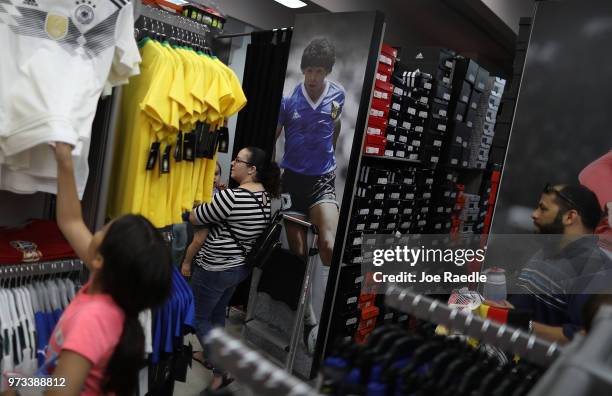 Ava Prego, Telvia Prego and Rodrigo Prego shop at the Soccer Locker store for German soccer team items as they prepare to show their support for...