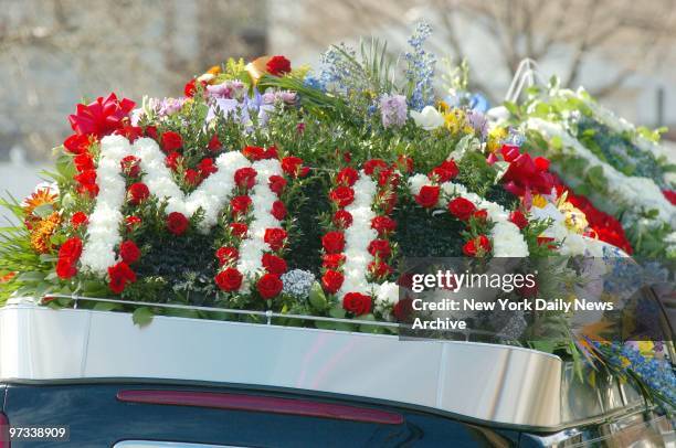 With an M.D. Floral arrangement atop the hearse, the coffin of Dr. Anthony Moretti is driven from Holy Rosary Catholic Church in Dongin Hills, Staten...
