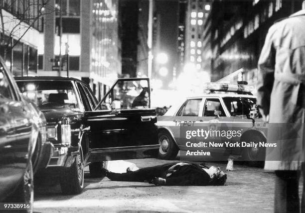 Driver and bodyguard Thomas Bilotti lies on the street next to car after he and crime boss Paul Castellano were shot to death outside East Side...