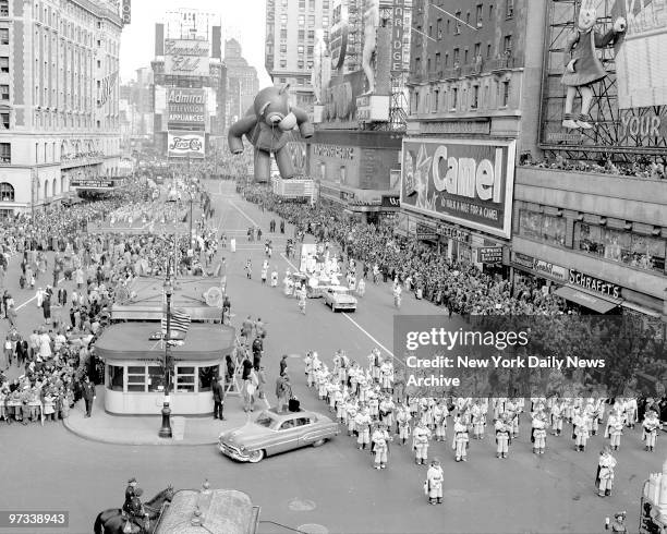 With fanfare by a band, the teddy Bear, all 40 feet of him, makes his way through Times Square as 33 attendants make sure he won't run away. The...