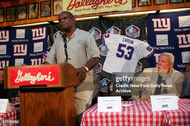 With former coach Bill Parcells looking on, New York Giants' linebacker Harry Carson speaks to the media during a news conference at Gallagher's...