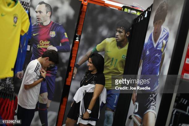 Matthias Meyer and his mother Vanessa Meyer shop at the Soccer Locker store for German soccer team items as they prepare to show their support for...