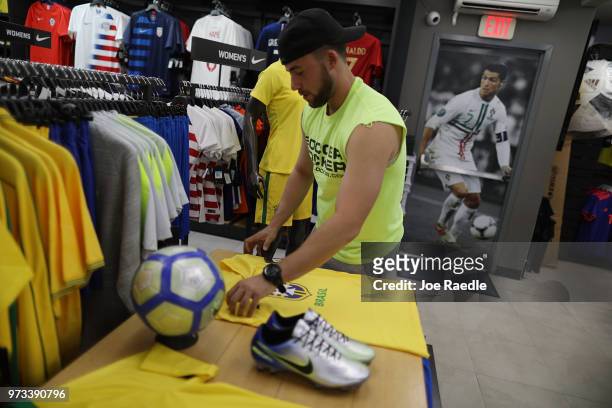 Kyle Cividanes shops at the Soccer Locker store for Brazilian soccer team items as he prepares to show his support for the team as it plays in the...