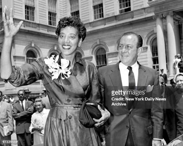 With Mayor Wagner standing by, Althea Gibson waves at City Hall to the crowd. The 29-year-old Harlem girl, who became the first black American ever...