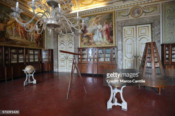 The library in the royal apartments inside the Royal Palace of Caserta, with a spyglass and a globe.