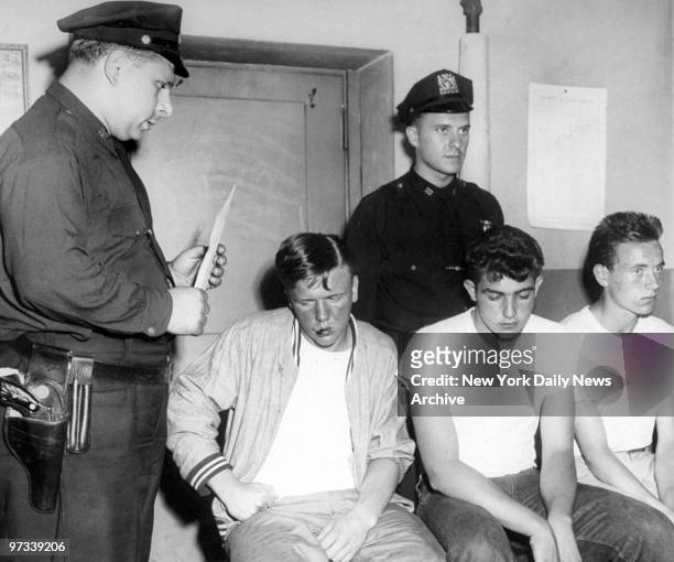 Patrolmen Anthony Pomaro and Pat McNamara book James Del Vecchio, Joseph Spagnolo and James Whitz at the 22d Precinct stationhouse. The three men...