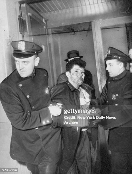 Patrolmen John Baker and Phillip Giardana escort Anthony Garcia into police station after Garcia attempted to rob a drug store.