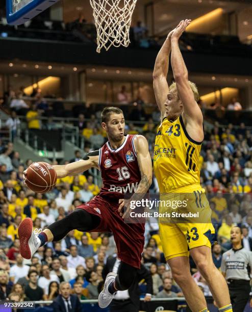 Stefan Jovic of Bayern Muenchen competes with Luke Sikma of ALBA Berlin during the fourth play-off game of the German Basketball Bundesliga finals at...