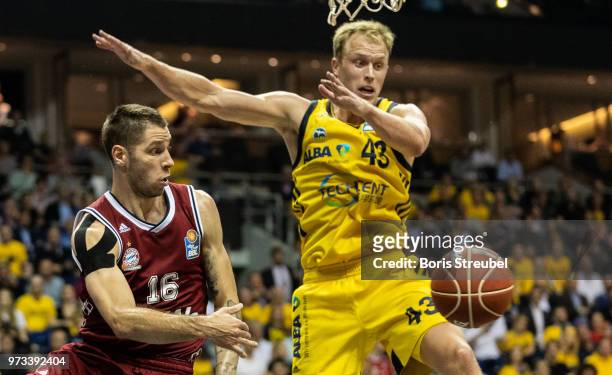 Stefan Jovic of Bayern Muenchen competes with Luke Sikma of ALBA Berlin during the fourth play-off game of the German Basketball Bundesliga finals at...