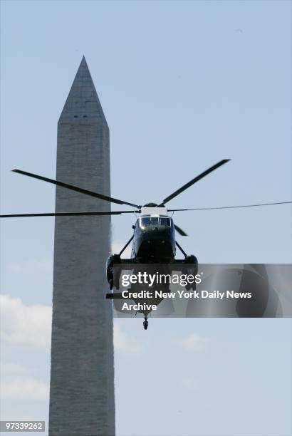 With the Washington Monument in the background, Marine One helicopter carries President George W. Bush from the White House to Andrews Air Force Base...
