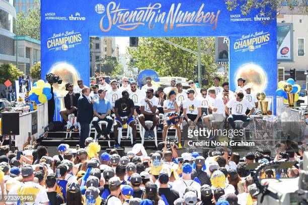 The Golden State Warriors pose for a group photo on stage during the Golden State Warriors Victory Parade on June 12, 2018 in Oakland, California....