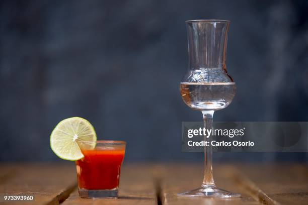 Sangrita and Mezcal photographed at Reposado tequila bar. In many regions of Mexico, it's far more likely to see tequila served with a "chaser" shot...