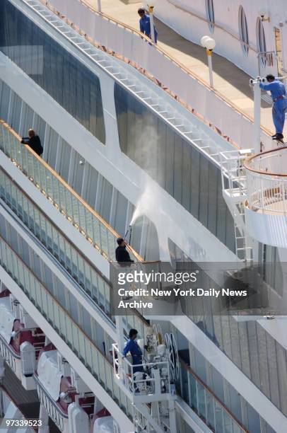 Worker prepare the Norwegian Dawn to sail while docked along the Hudson River off the West side of Manhattan. The luxury liner sailed into port this...