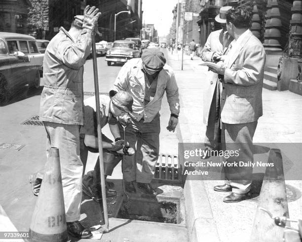 Workers conduct search for gun in sewer at 68th Street and Central Park West. Frank Costello escaped death by just happening to turn his head at the...