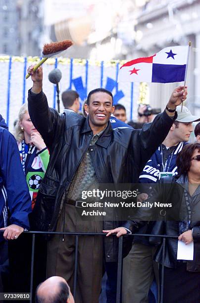 World Series MVP Mariano Rivera celebrates with a flag and broom during the New York Yankees' 1999 World Series Victory Parade.