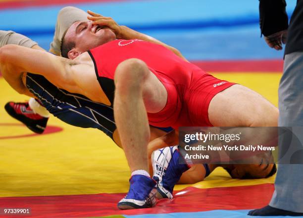 Wrestler Cael Sanderson of the U.S. Grapples with Eui Jae Moon of Korea during the men's freestyle 84kg final match in the Ano Liossia Olympic Hall...