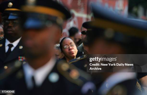 Yanisse Oliveras mourns as honor guard folds a flag over the coffin during funeral services for her husband, Army Spec. Hai Ming Hsia, at St. James...