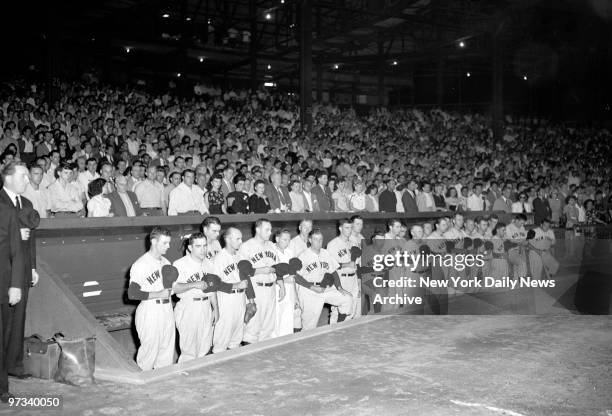 Yankee ball team and fans stand in solemn silence at the Polo Grounds after announcement of Babe Ruth's death.