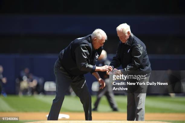 Yankee legends Don Larsen and Whitey Ford get the dirt on new Stadium as they collect piece of mound during pregame ceremonies, highlighted by jets...
