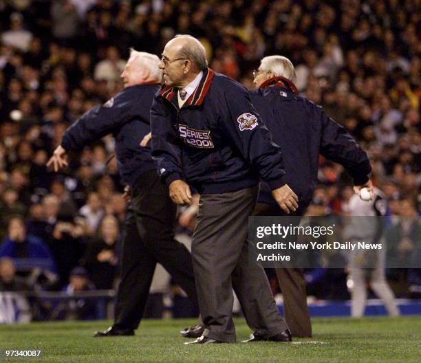 Yankee legends Whitey Ford , Yogi Berra , and Phil Rizzuto throw out the ceremonial first pitches before the start of Game 4 of the World Series...
