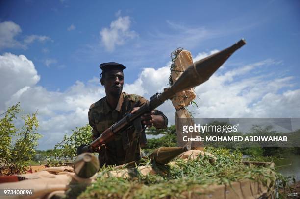 Somali soldier holds a mortar gun at Sanguuni military base, where an American special operations soldier was killed by a mortar attack on June 8,...