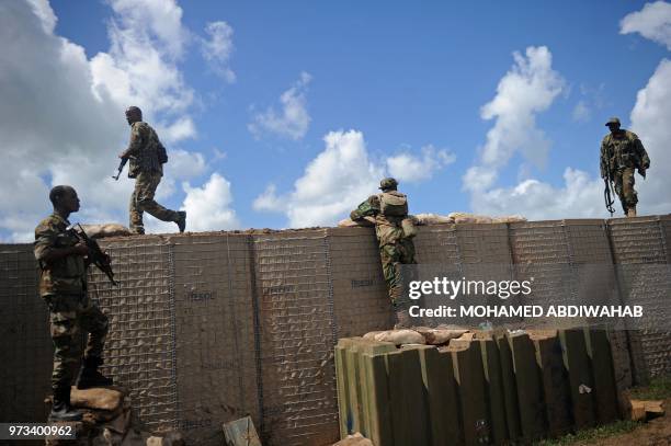 Somali soldiers are on patrol at Sanguuni military base, where an American special operations soldier was killed by a mortar attack on June 8, about...