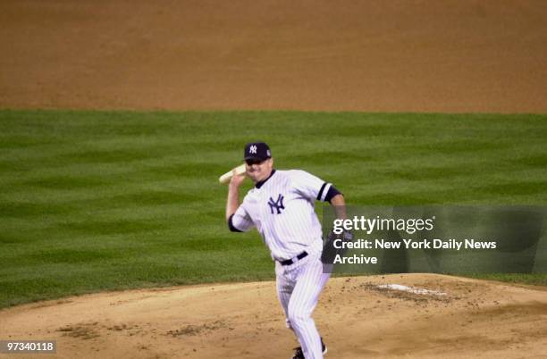 Yankee pitcher Roger Clemens throws a piece of broken bat back at Mike Piazza.. Game 2, World Series at Yankee Stadium