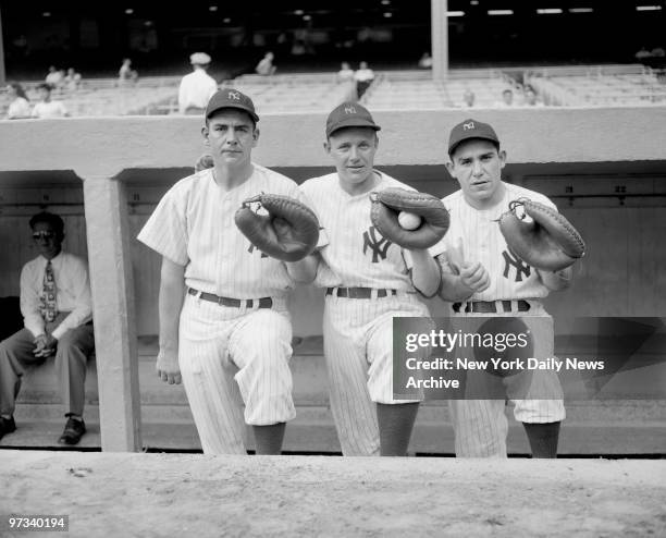 Yankees catchers Aaron Robinson, Ralph Houk, and Yogi Berra , two days before the team clinched the American League pennant, in Bucky Harris's first...