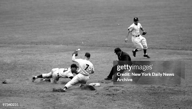 Yankees' Mickey Mantle, playing second base for first time, tries to tag Lemon of the Cleveland Indians. Umpire Napp calls the runner safe as...