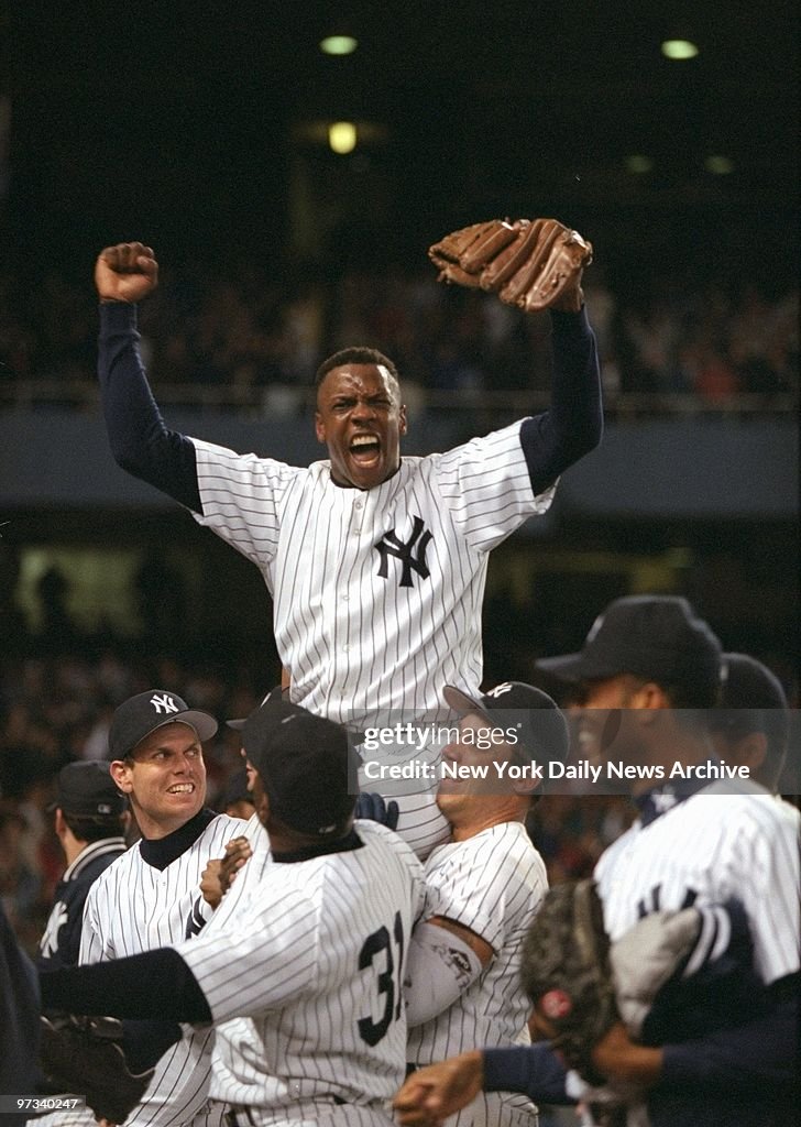 Yankees' pitcher Dwight Gooden is carried from the field by 