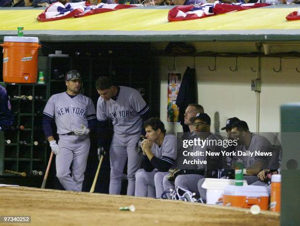 Yankees' players sit dejected in the dugout during the ninth inning against the Oakland Athletics. The A's went on to defeat New York, 5-3, in game...