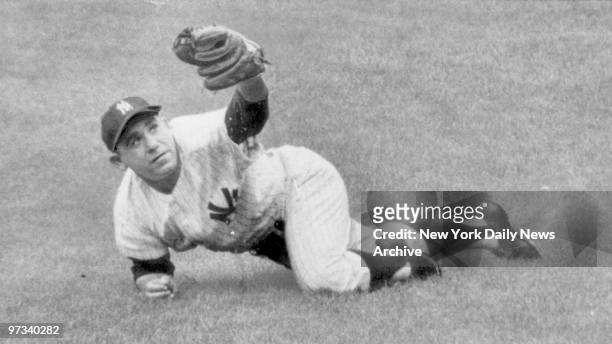 Yankees Yogi Berra makes three-point landing after snagging short fly to right in third frame of yesterday's tilt with Baltimore at the Stadium. Five...