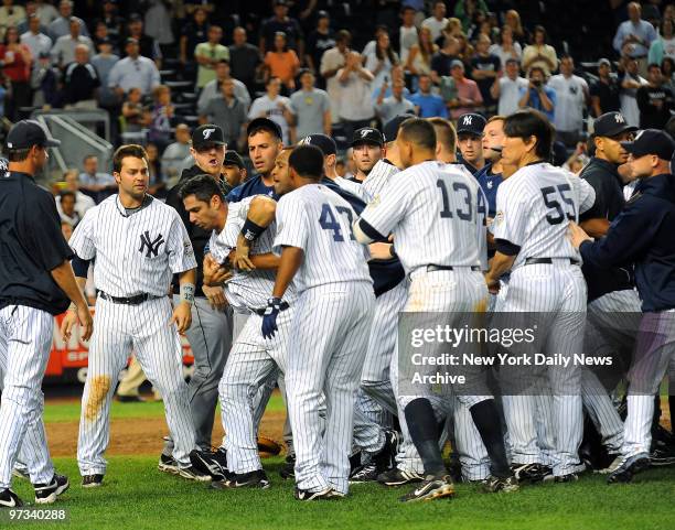 Yanks pull away irate Jorge Posada after his eighth-inning run in with Blue Jays pitcher Jesse Carlson quickly escalates into benches-clearing fracas...
