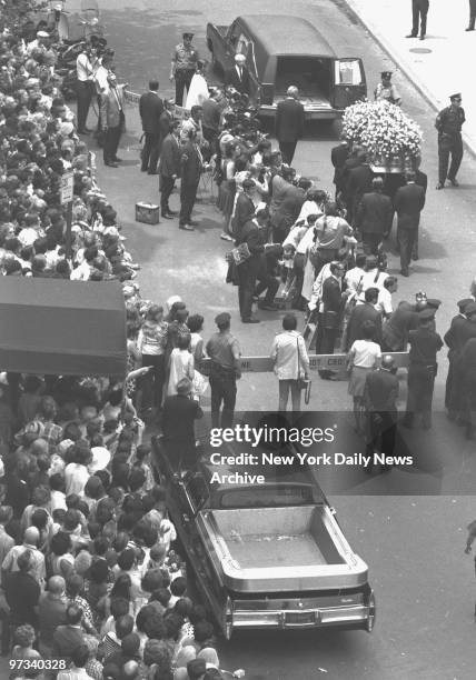 Yellow roses cover Judy Garland's coffin as it is taken to hearse at Campbell Funeral Home.