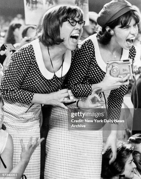 Young Beatles fans let loose with shrieks during concert at Shea Stadium. Beatles played to a packed house of 55,000 fans, some of whom used police...