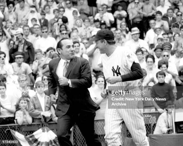 Yogi Berra with Ralph Houk running onto the field at Yankee Stadium for a ceremony honoring Mickey Mantle.