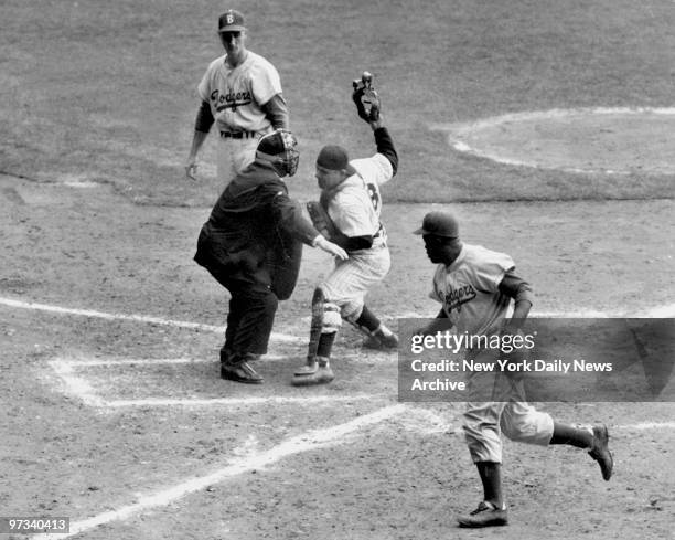 Yogi has it Out. Jackie Robinson, with two out in the eighth inning and the Dodgers trailing, 6-4, in the Series opener at the Stadium, tried to...