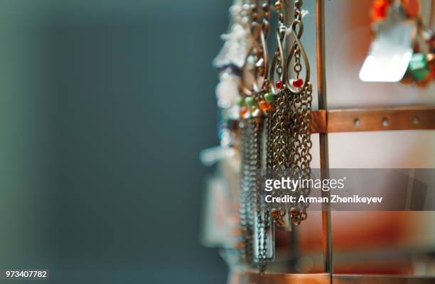 handmade jewelry on a showcase. horizontal close-up view - arman zhenikeyev fotografías e imágenes de stock