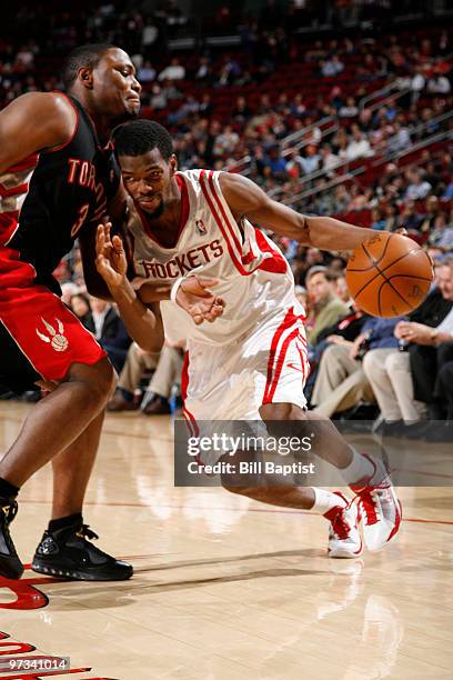 Aaron Brooks of the Houston Rockets drives the ball past Marcus Banks of the Toronto Raptors on March 1, 2010 at the Toyota Center in Houston, Texas....