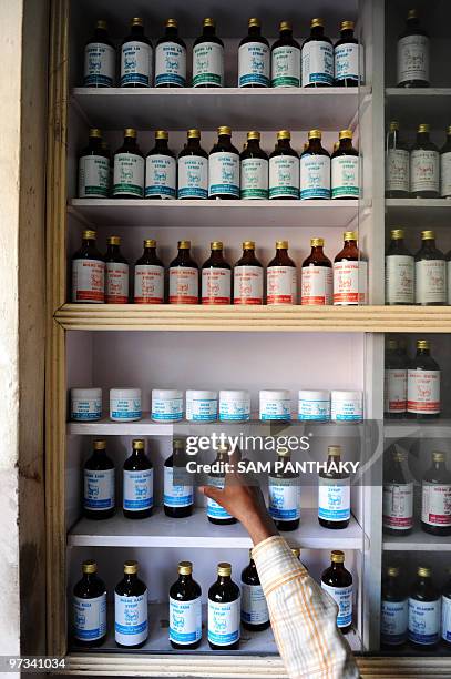 India-science-medicine-research-cows,FEATURE by Rupam Jain Nair This photo taken on February 27, 2010 shows storekeeper Pappu Yadav picking out a...